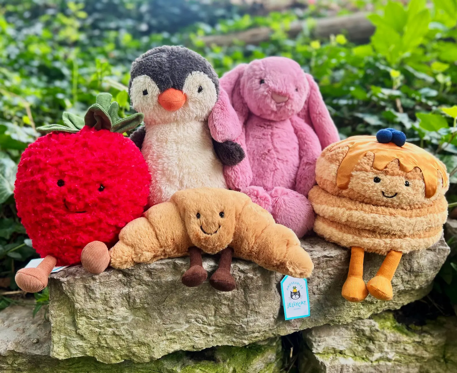 A collection of colorful Jellycat Amuseable plush toys